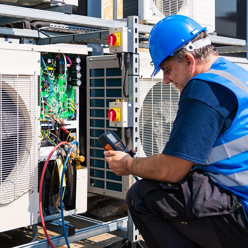 Engineer maintaining air con units