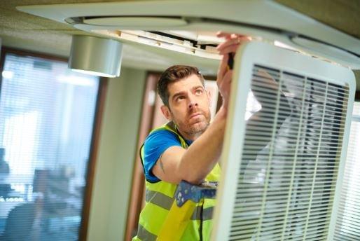Engineer installing an air conditioning system